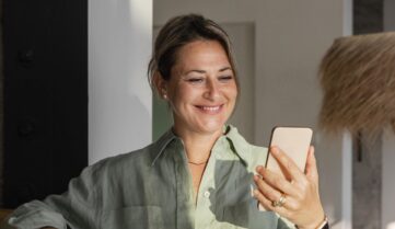 medium shot woman holding phone min scaled