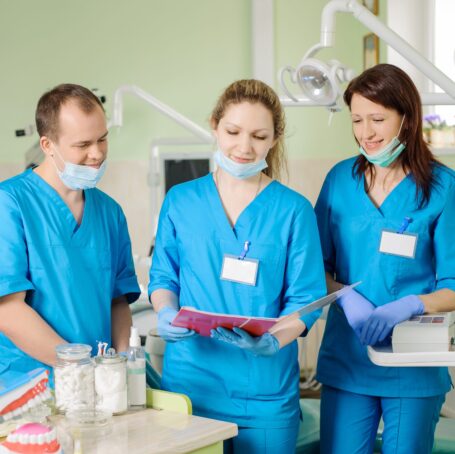 three dentists looking at the folder at the stomat 2023 11 27 05 18 57 utc scaled